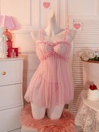 Soft pink babydoll dress with ruffled straps for a romantic and playful look