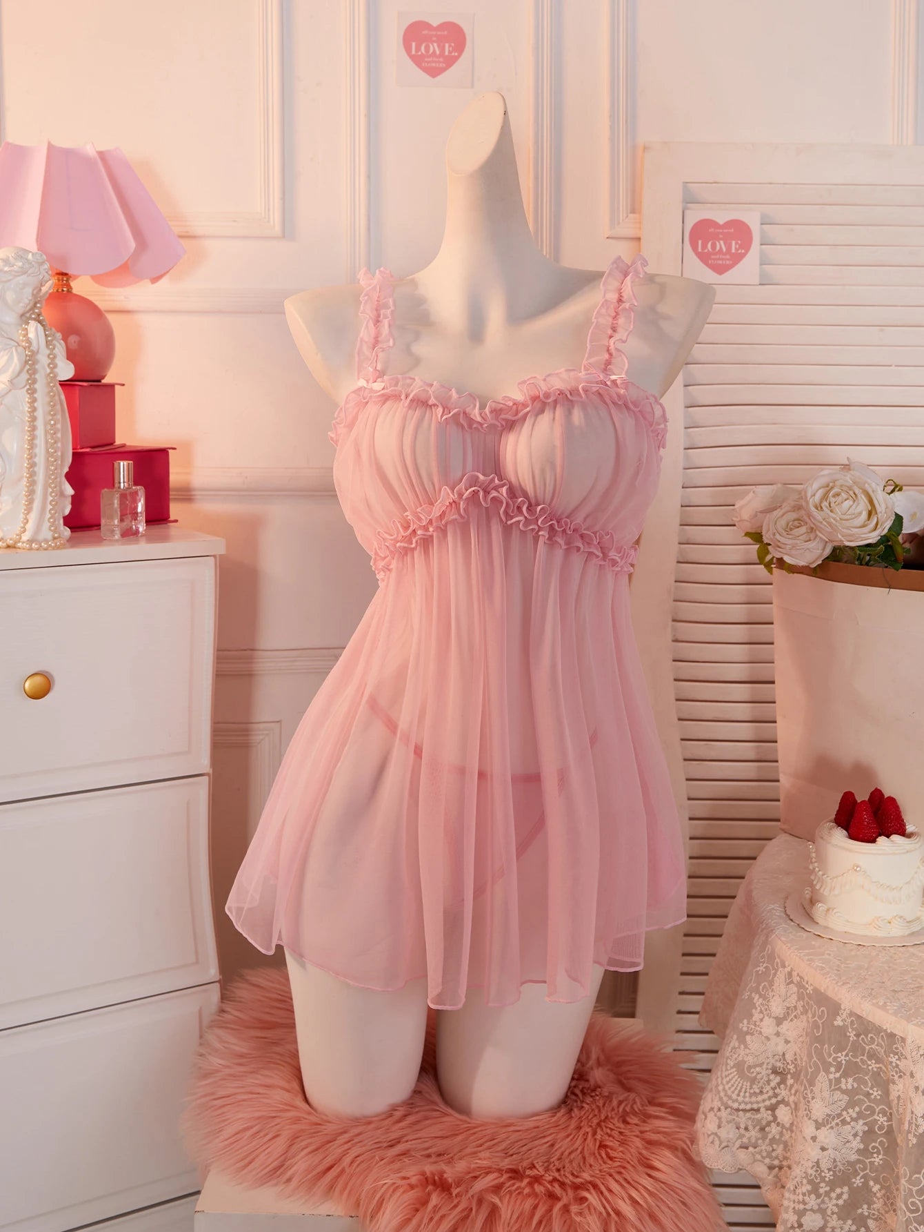 Soft pink babydoll dress with ruffled straps for a romantic and playful look