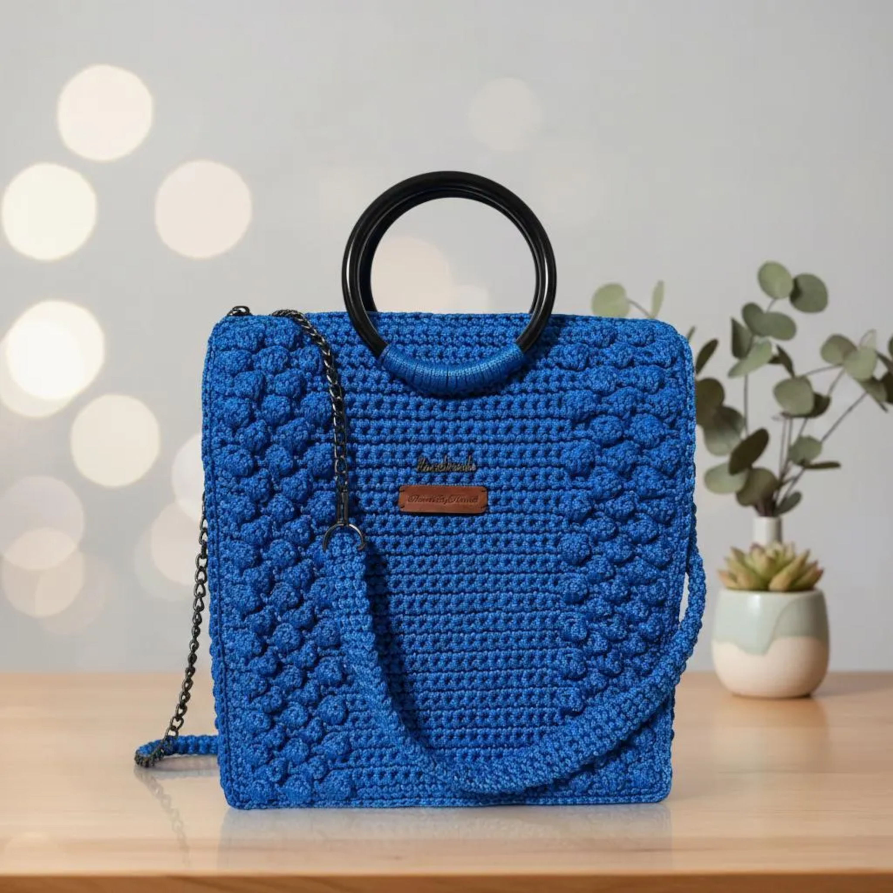 Handmade blue tote bag for crochet with stylish black handles and shoulder strap