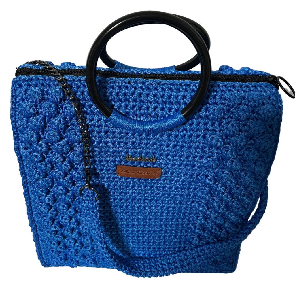 Blue crochet tote bag for crochet with black handles and a stylish design
