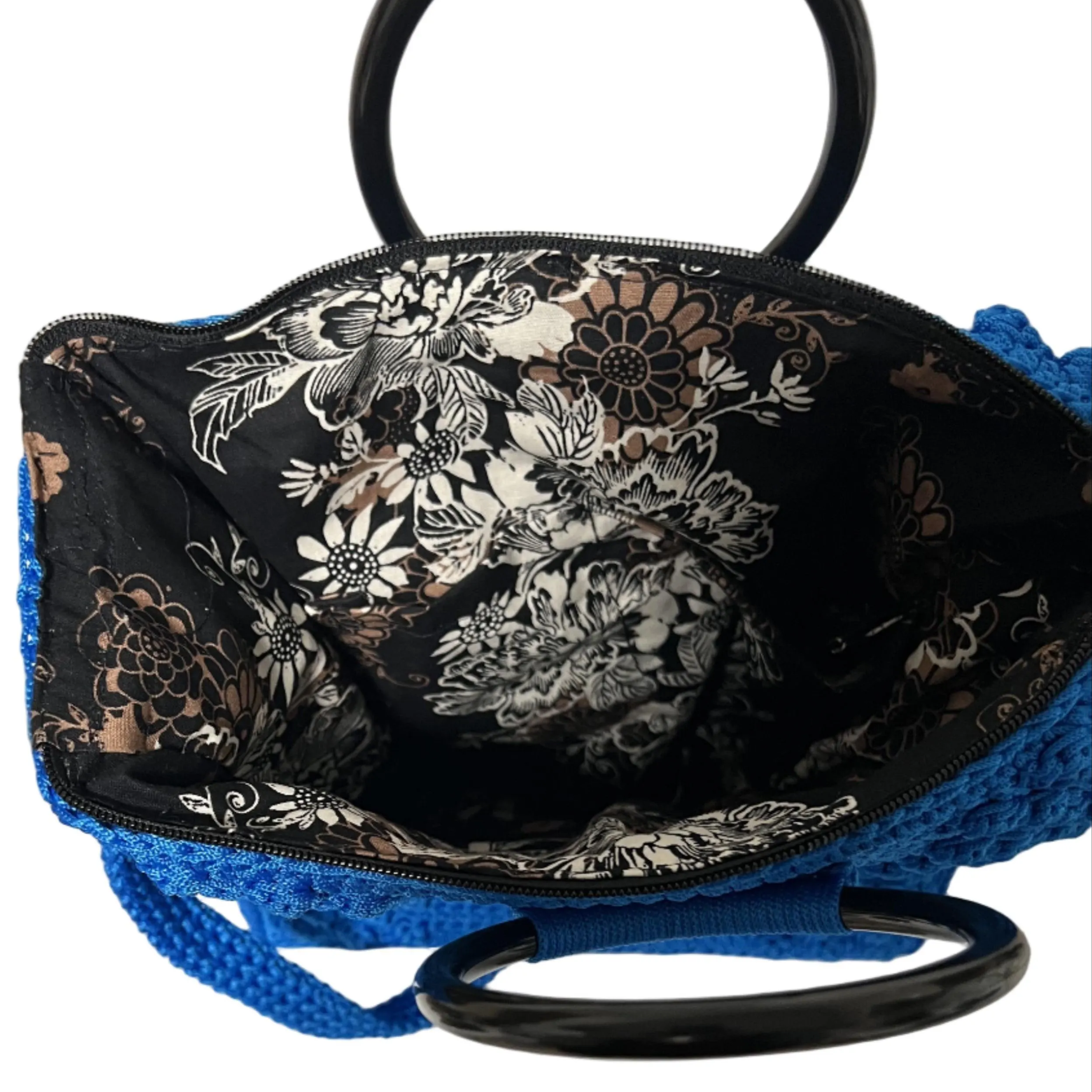 Blue crochet tote bag for crochet with a floral patterned interior and black handles