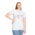 White be still bible verse t shirt with floral design worn by smiling woman in blue jeans