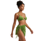 Green beachwear bathing suits featuring a stylish top and wrap skirt for summer outings