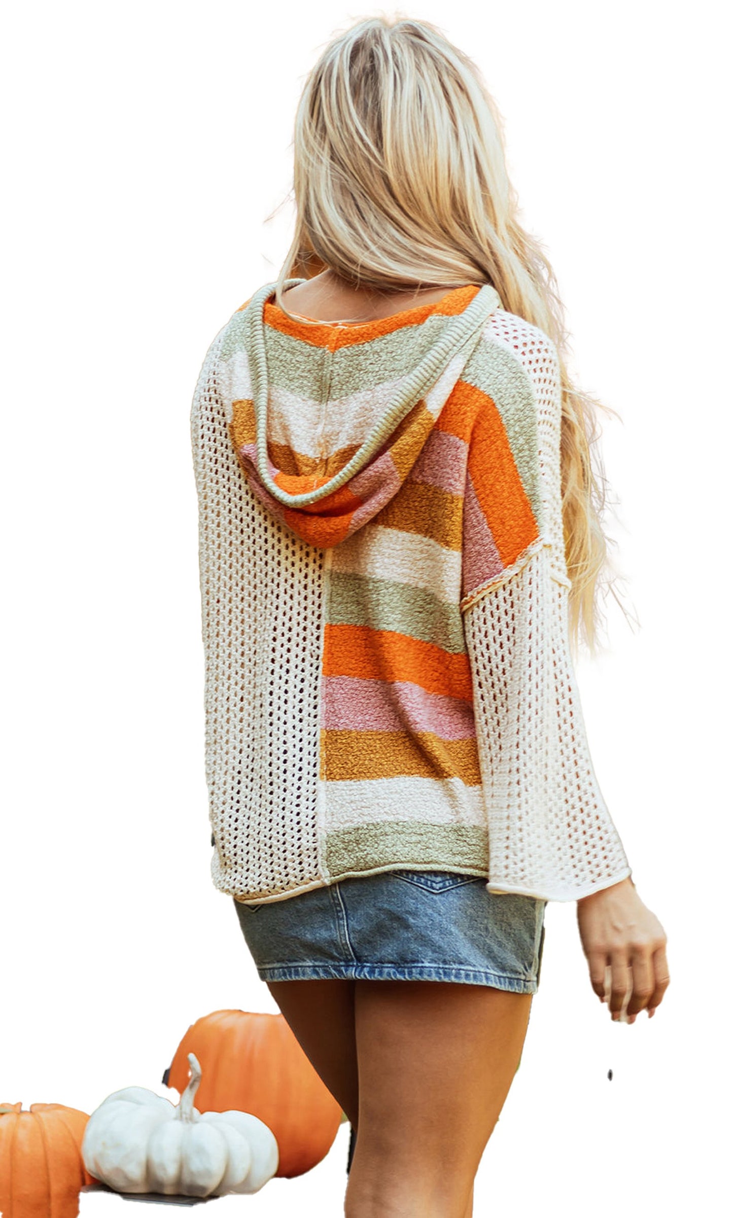 Back view of a woman wearing a beige oversized colorblock sweater with a hood and loose sleeves