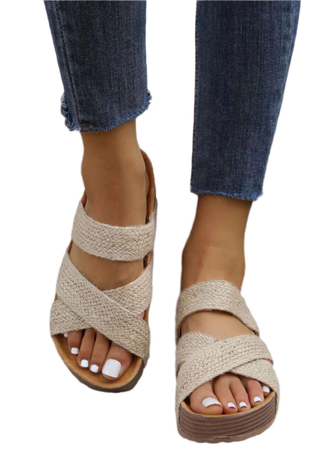 Beige woven slip-on sandals by LuckeLadybug LLC worn with blue denim jeans