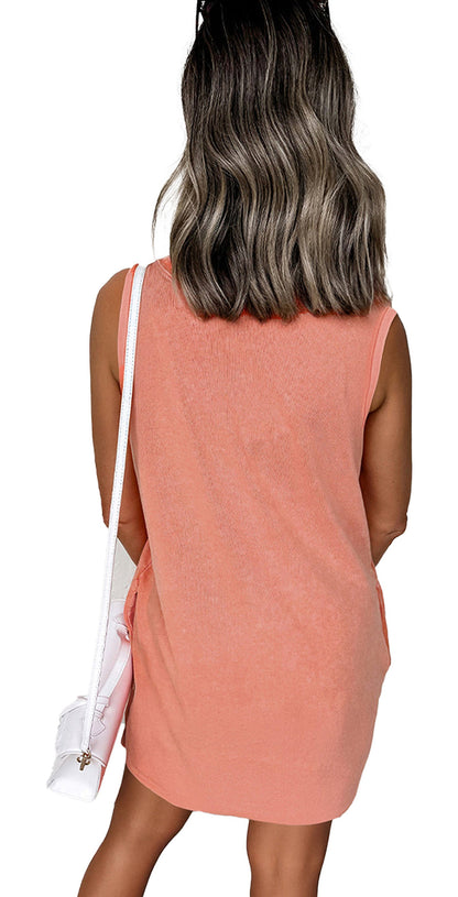 Back view of model wearing LuckeLadybug Phalaenopsis tank mini dress with pockets. Coral sleeveless casual look
