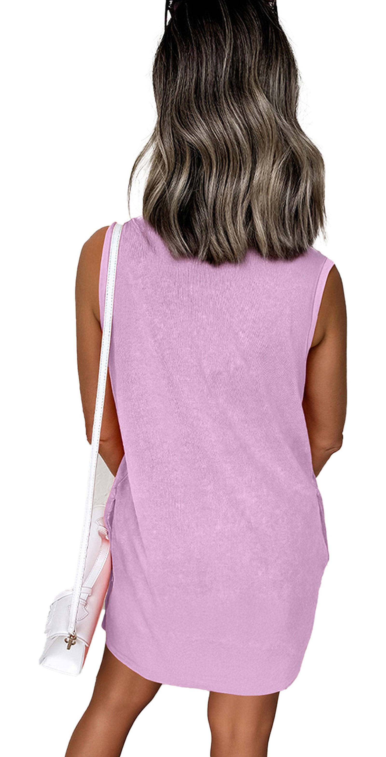 Back view of woman wearing Phalaenopsis tank mini dress with pockets. Lavender pink sleeveless style with white shoulder bag