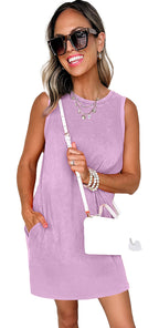 Model wearing Phalaenopsis tank mini dress with pockets. Lavender sleeveless mini dress with white purse and sunglasses