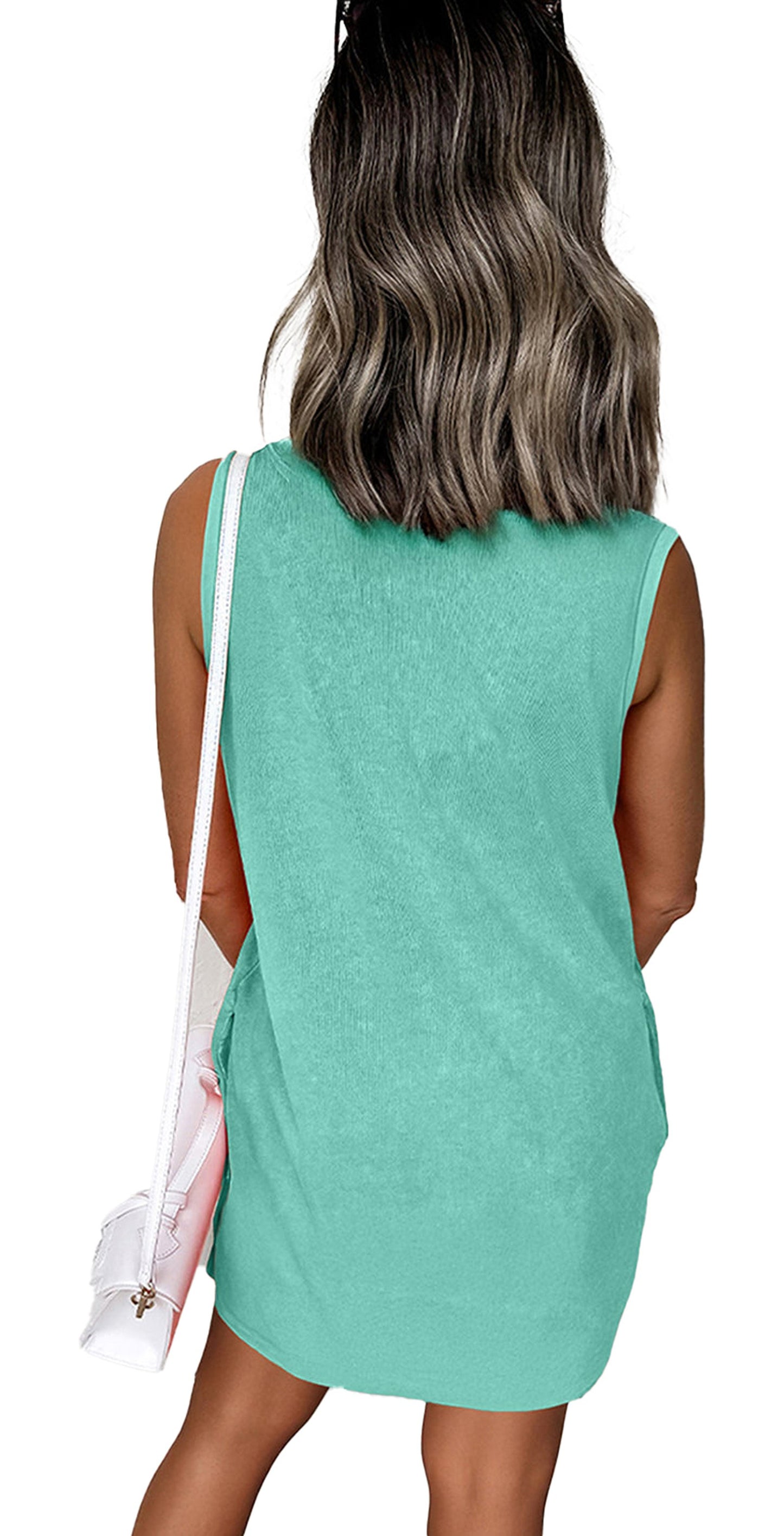LuckeLadybug model wearing Phalaenopsis tank mini dress with pockets. Mint green back view with white shoulder bag
