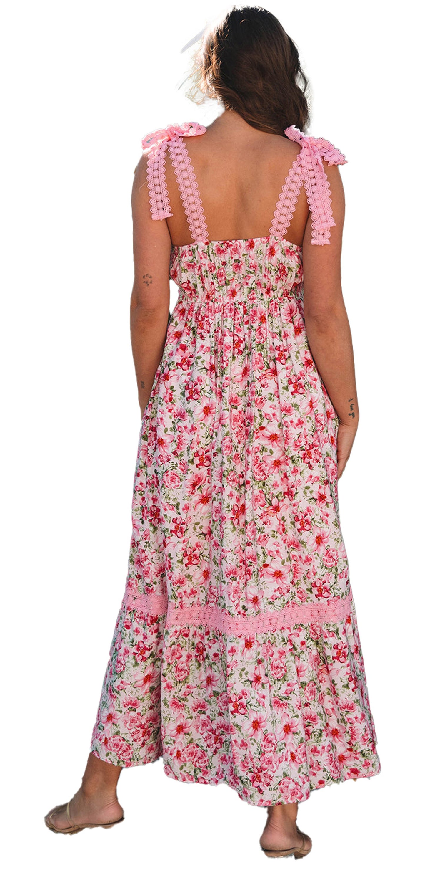 Back view of model wearing LuckeLadybug pink floral maxi dress with smocked bodice and pompom tie straps