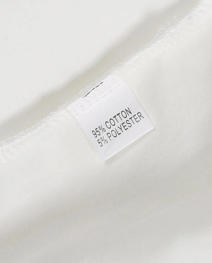 Care label on plaid romper baby clothes showing 95 percent cotton and 5 percent polyester composition