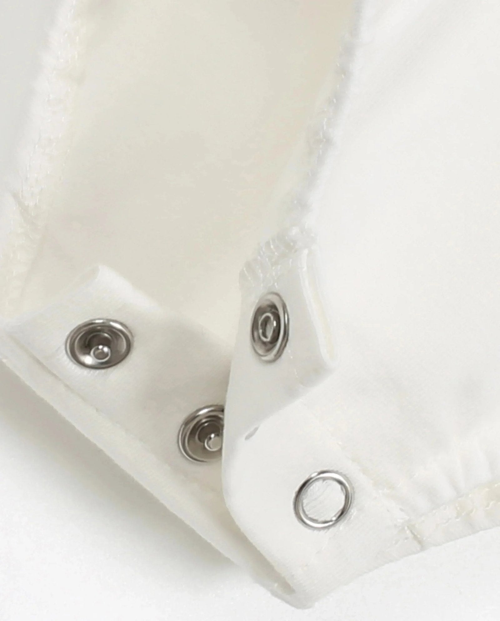 Close-up of snaps on plaid romper baby clothes for easy dressing and comfort