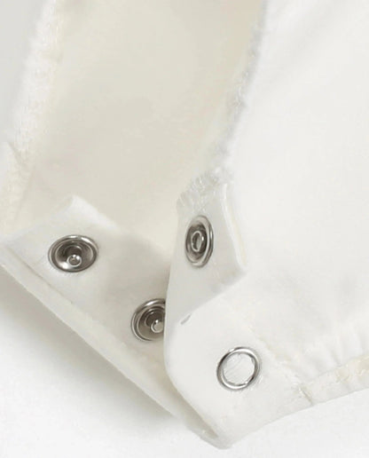 Close-up of snaps on plaid romper baby clothes for easy dressing and comfort