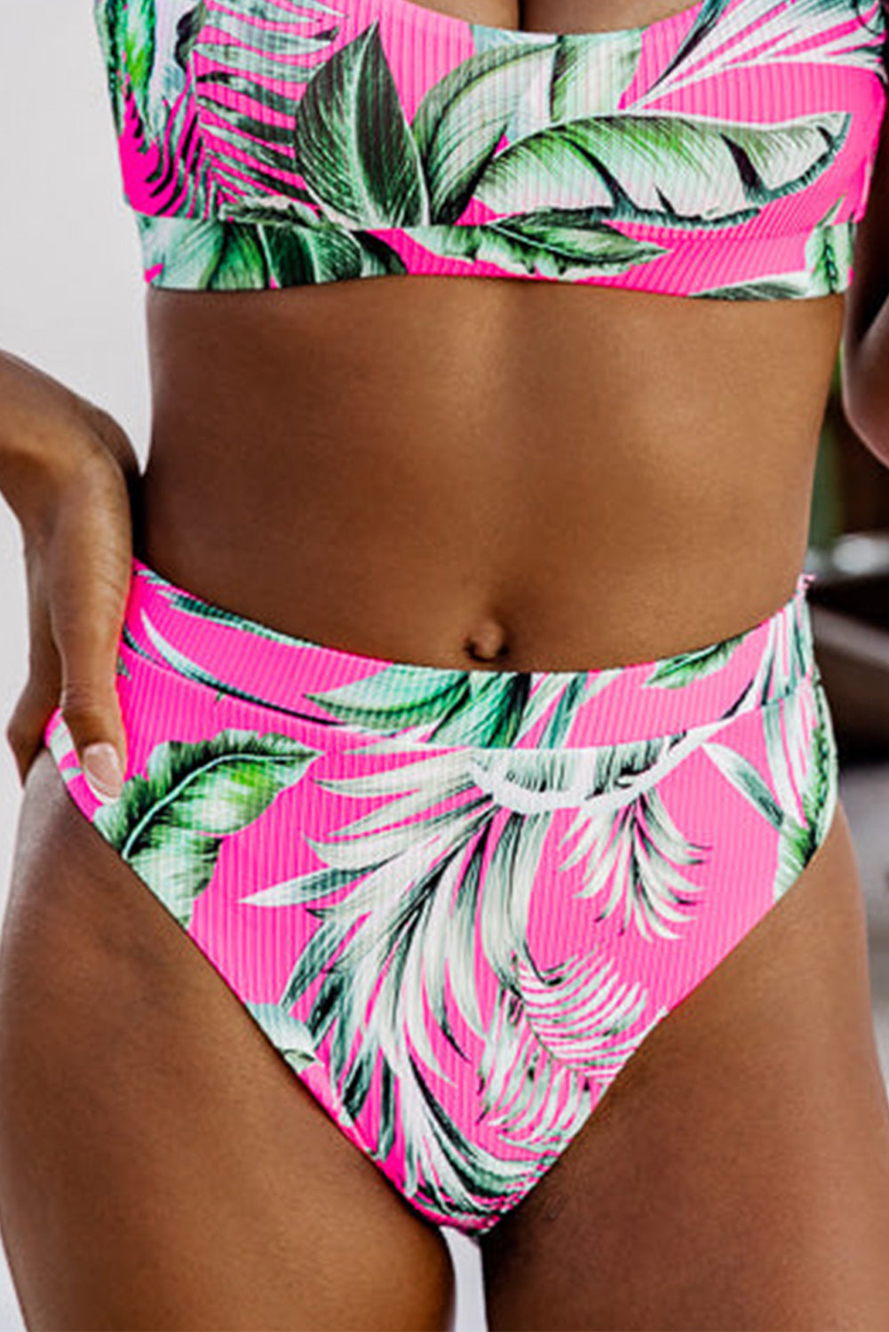 Bright pink bikini bottoms with tropical leaf print for stylish summer beachwear