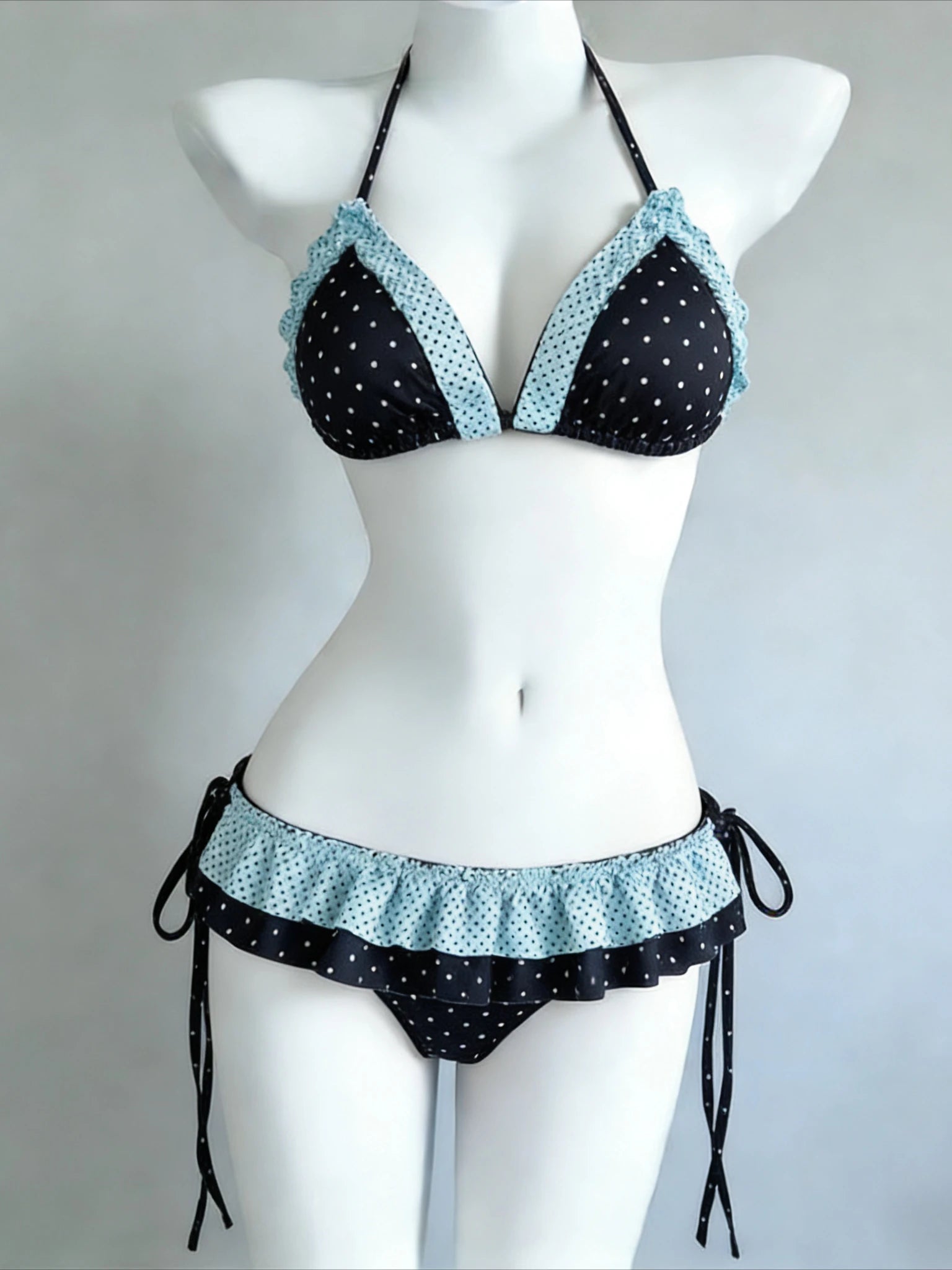 LuckeLadybug LLC bikini with high waist featuring ruffled edges and polka dot pattern in black and blue