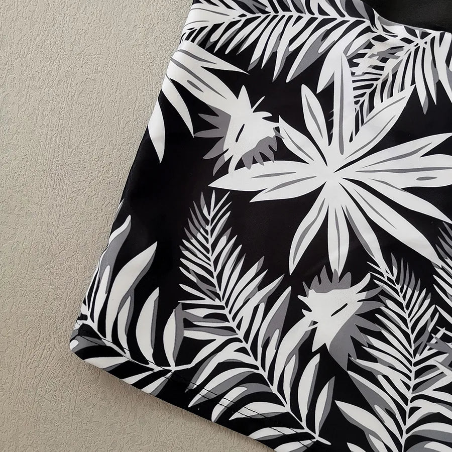 LuckeLadybug LLC bikini with high waist featuring a stylish black and white tropical leaf pattern