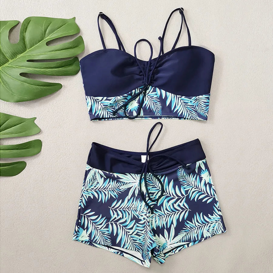 LuckeLadybug LLC bikini with high waist featuring a navy and tropical leaf design for stylish summer wear