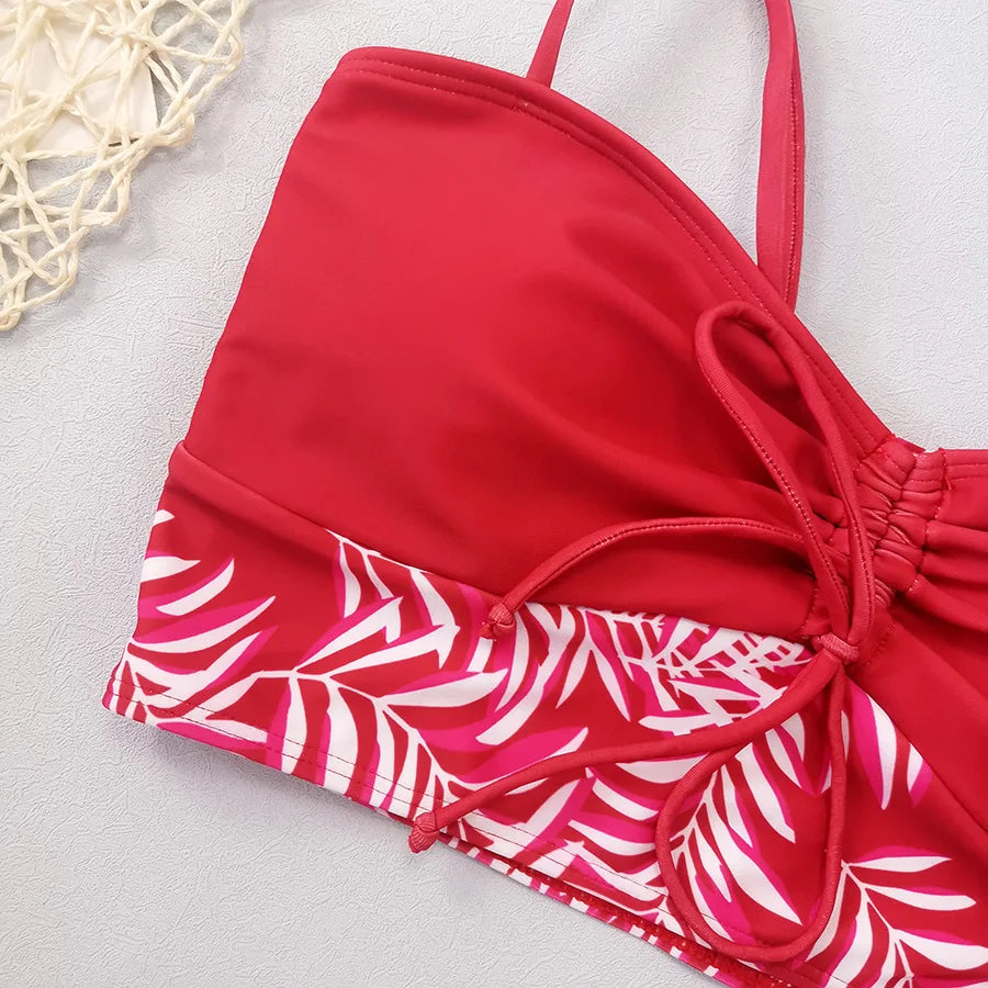 Red bikini with high waist featuring a stylish tropical leaf print design