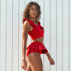 Red bikini with high waist featuring ruffled top and playful design for stylish beachwear