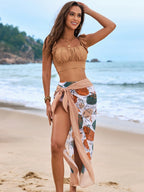LuckeLadybug LLC bikini with high waist paired with a stylish wrap skirt on the beach