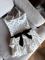 Polka dot high waist bikini with ruffled skirt and black bow detail by LuckeLadybug LLC