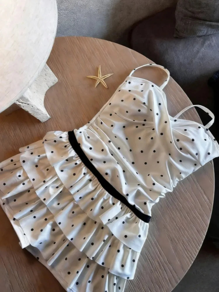 Stylish bikini with high waist in white with black polka dots and ruffle detailing from LuckeLadybug LLC