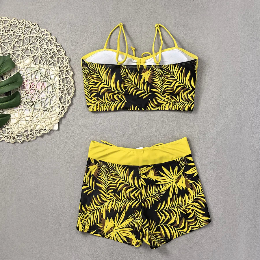 LuckeLadybug LLC bikini with high waist featuring a tropical leaf pattern in yellow and black