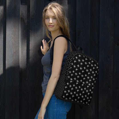 LuckeLadybug black backpack with white stars stylishly worn by a model outdoors