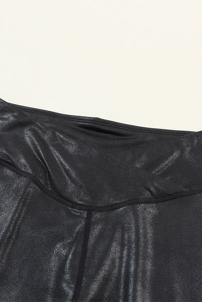 Close-up of black leather leggings for women by LuckeLadybug showing shiny textured fabric and stitching details