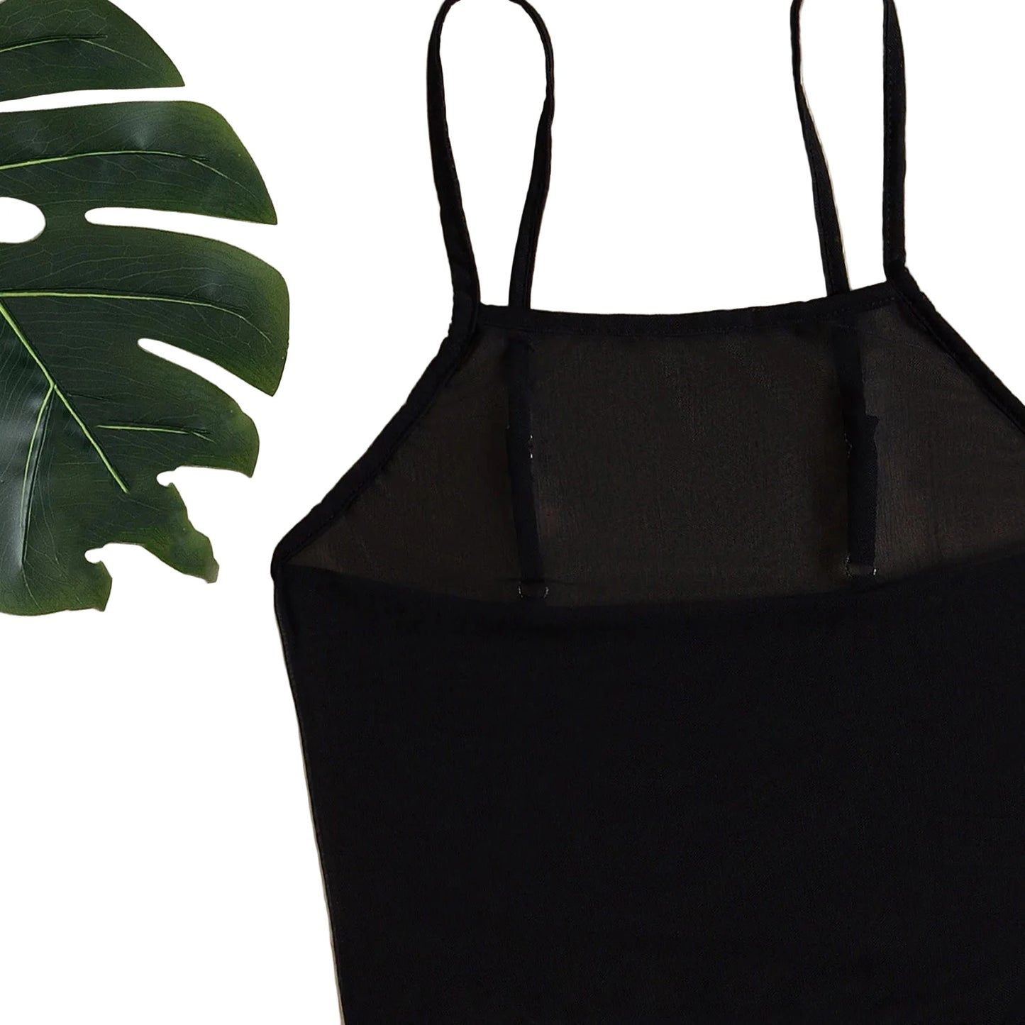 Black mesh beach cover up dress with adjustable straps against a leafy background