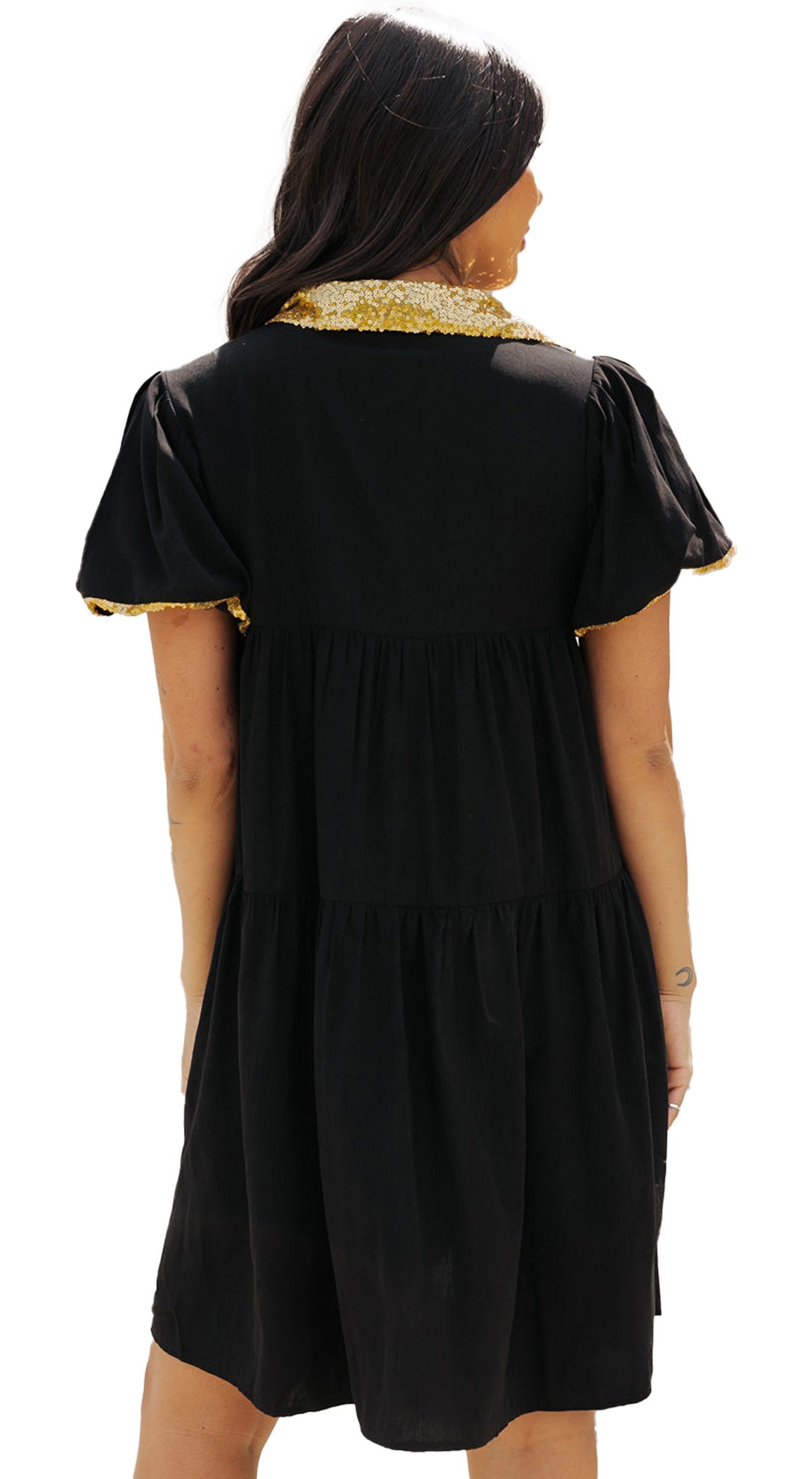 Back view of a black sequin game day shirt dress with gold trim and puff sleeves from LuckeLadybug