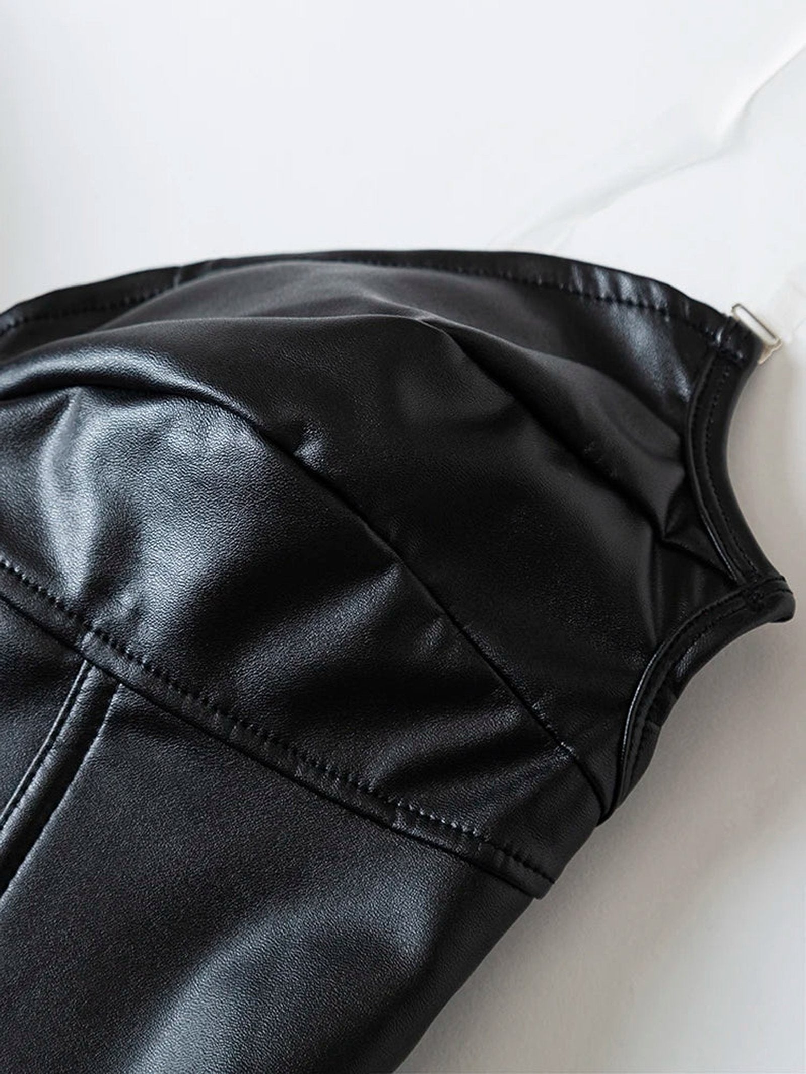 Close-up of a black strapless corset top featuring a sleek finish and structured design