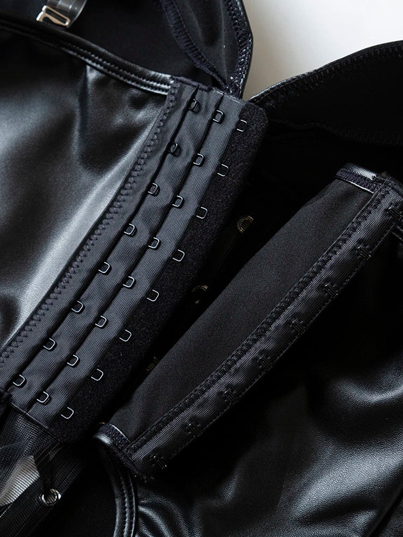 Close-up of LuckeLadybug LLC black strapless corset top showcasing hooks and sleek material