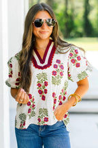 LuckeLadybug LLC floral blouse featuring vibrant floral design and stylish puff sleeves