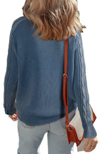 Back view of a blue cable knit sweater for women with textured fabric and relaxed fit