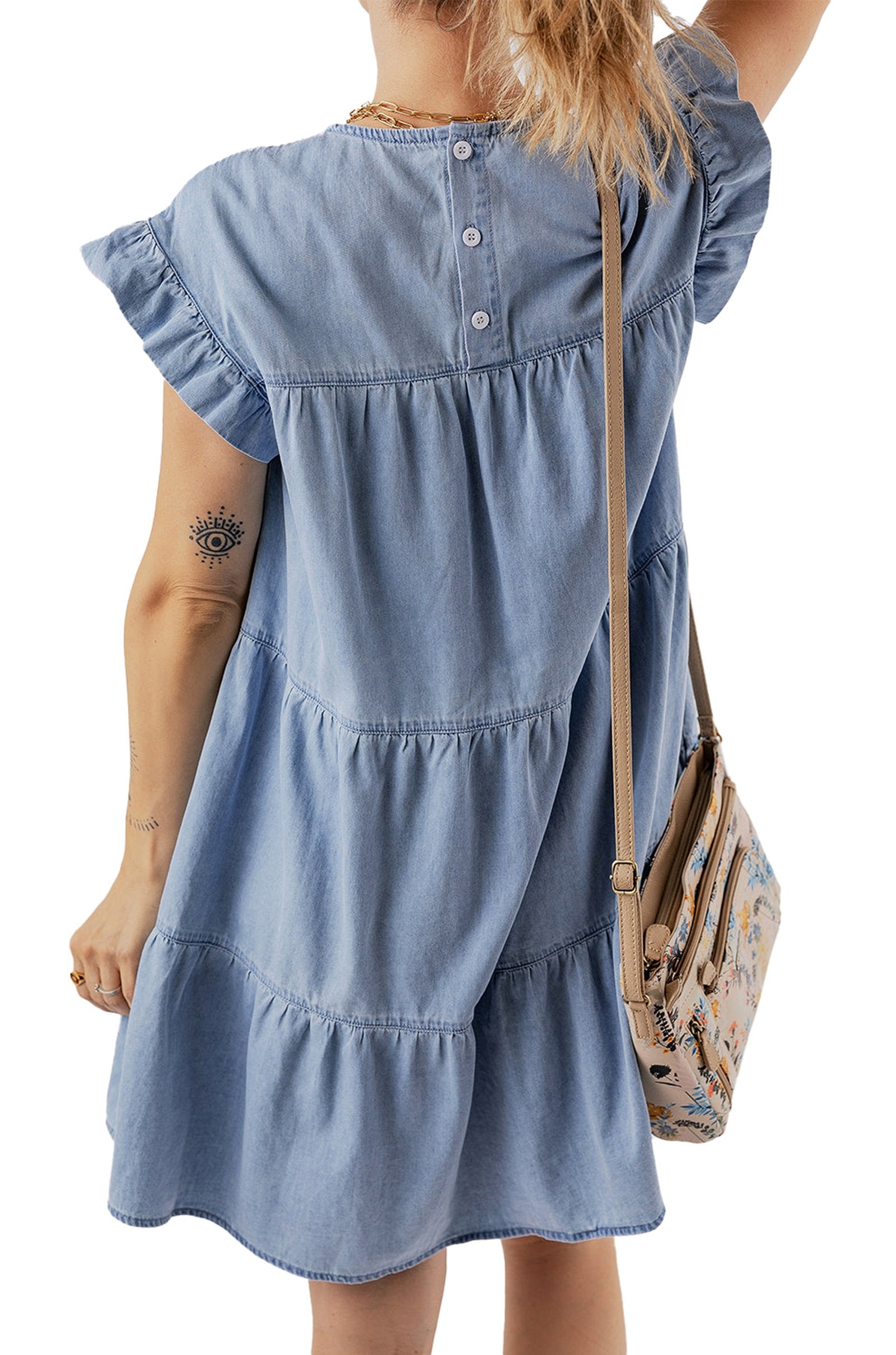 Back view of a blue denim ruffle dress with tiered design and short sleeves