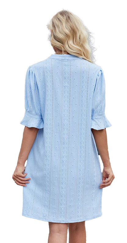 Back view of a blue jacquard mini dress from LuckeLadybug with puff sleeves and delicate patterns