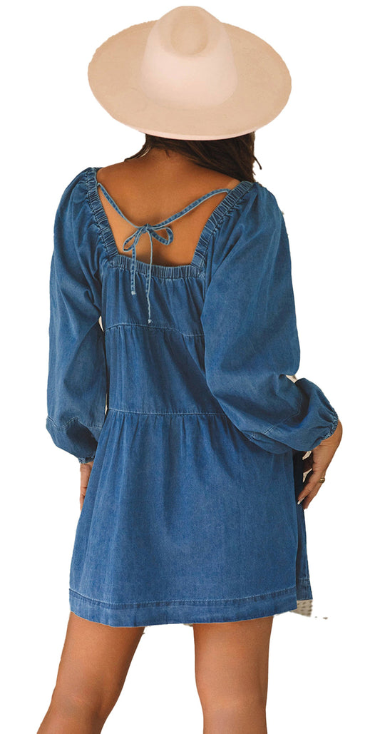Back view of model in dusk blue denim mini dress with tie open back long puff sleeves boho hat