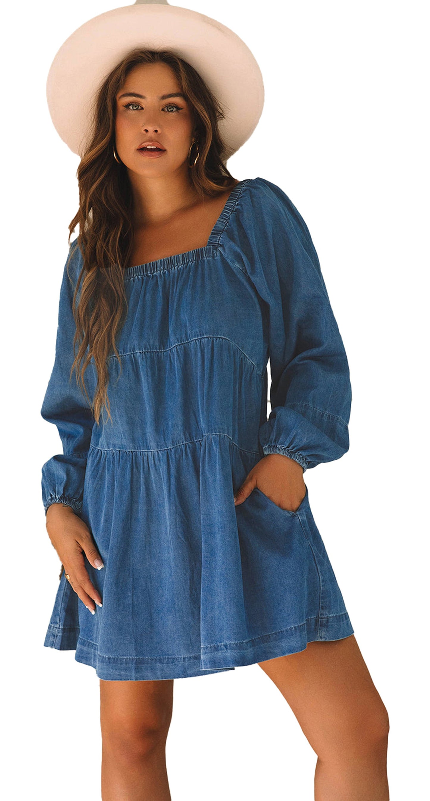 Woman in a dusk blue denim mini dress with long puff sleeves square neckline and pockets