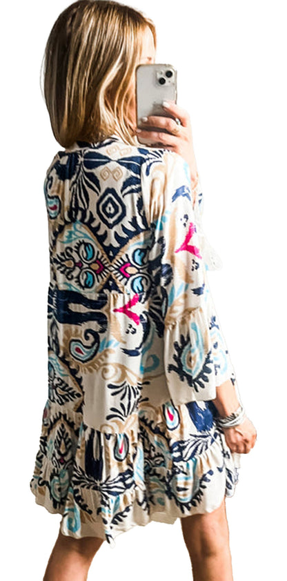 Woman mirror selfie wearing LuckeLadybug white tribal print mini dress with long sleeves and tiered ruffle hem