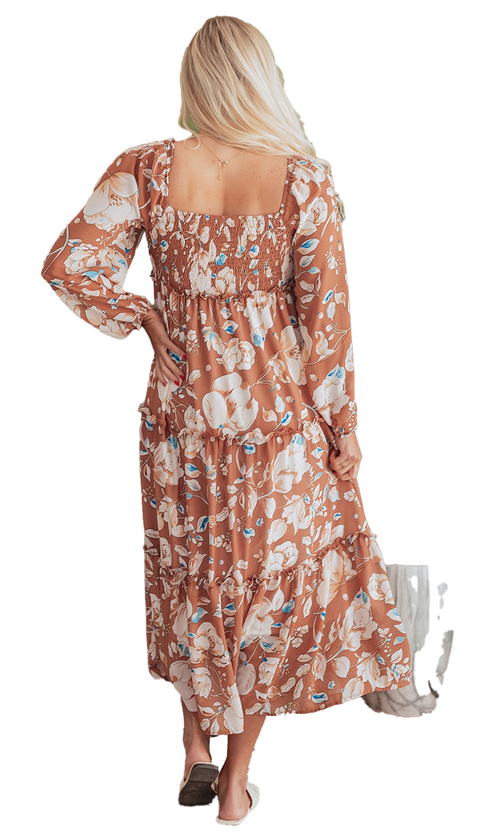 Rear view of woman in brown floral maxi dress with smocked square back long sleeves and tiered skirt