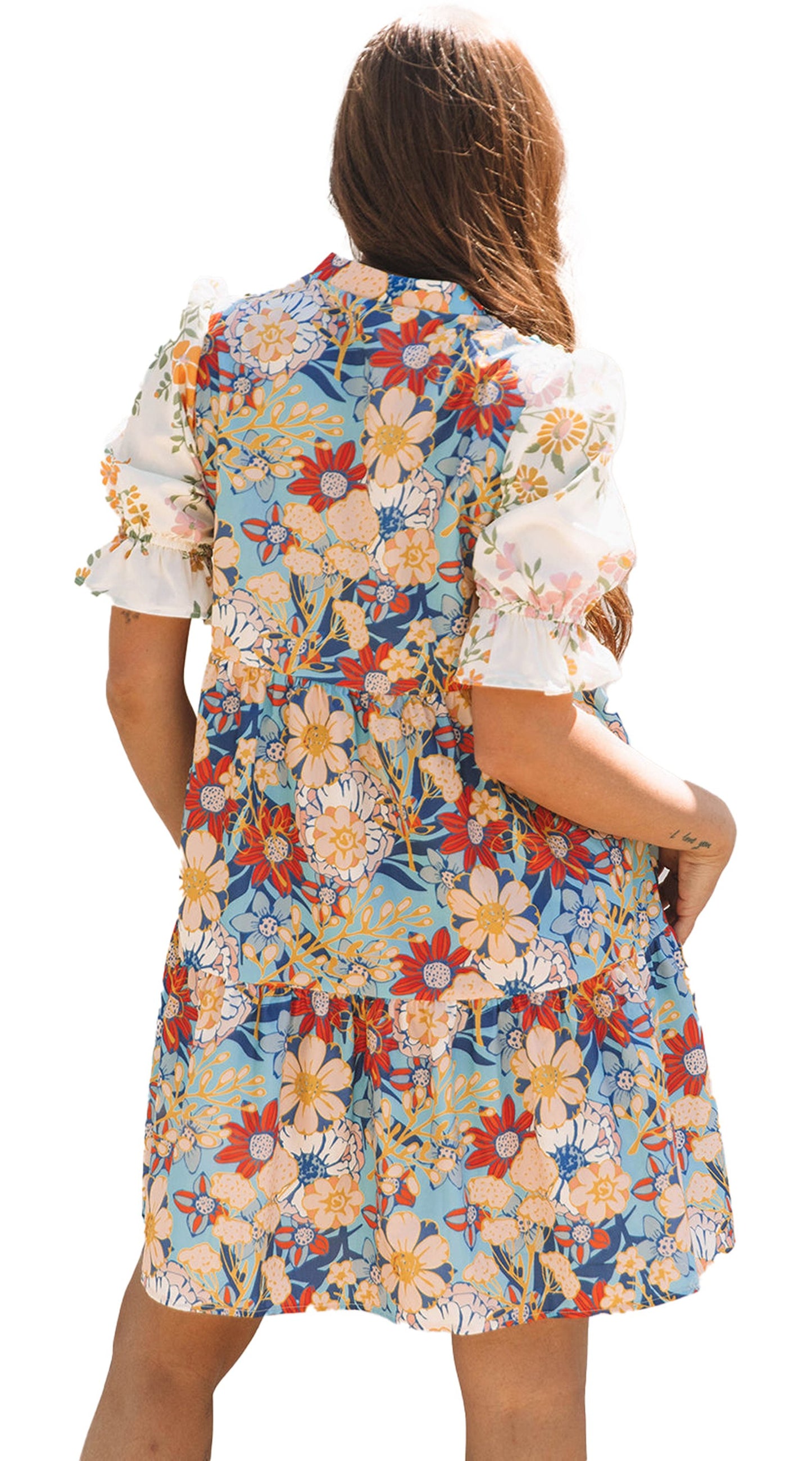 Back view of a LuckeLadybug boho floral mini dress with colorful floral patterns and puffy sleeves