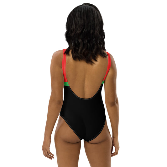 Back view of bold color one-piece swimsuit with black, red, and green design by LuckeLadybug