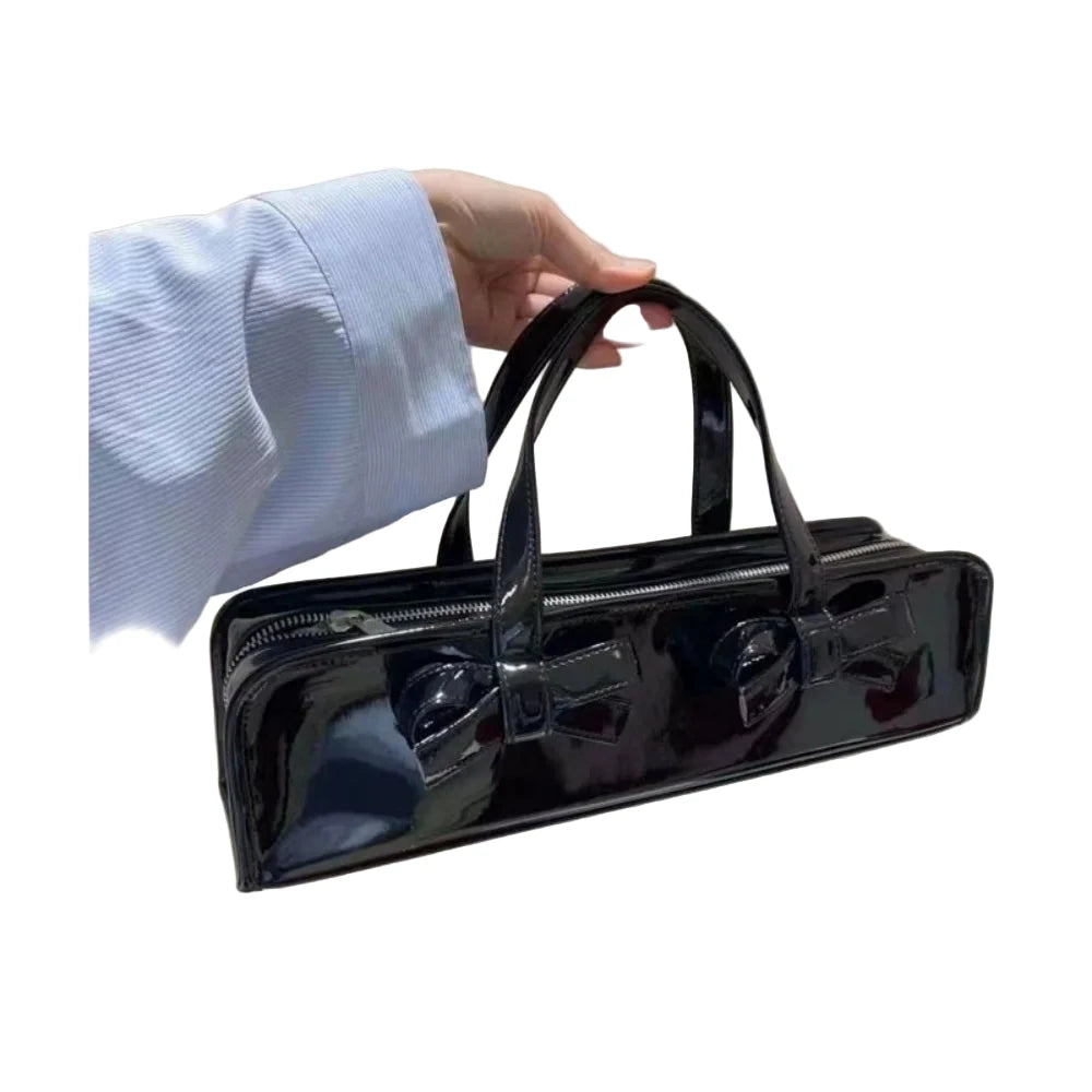 Shiny black bow handbag for women with dual handles and zippered compartments