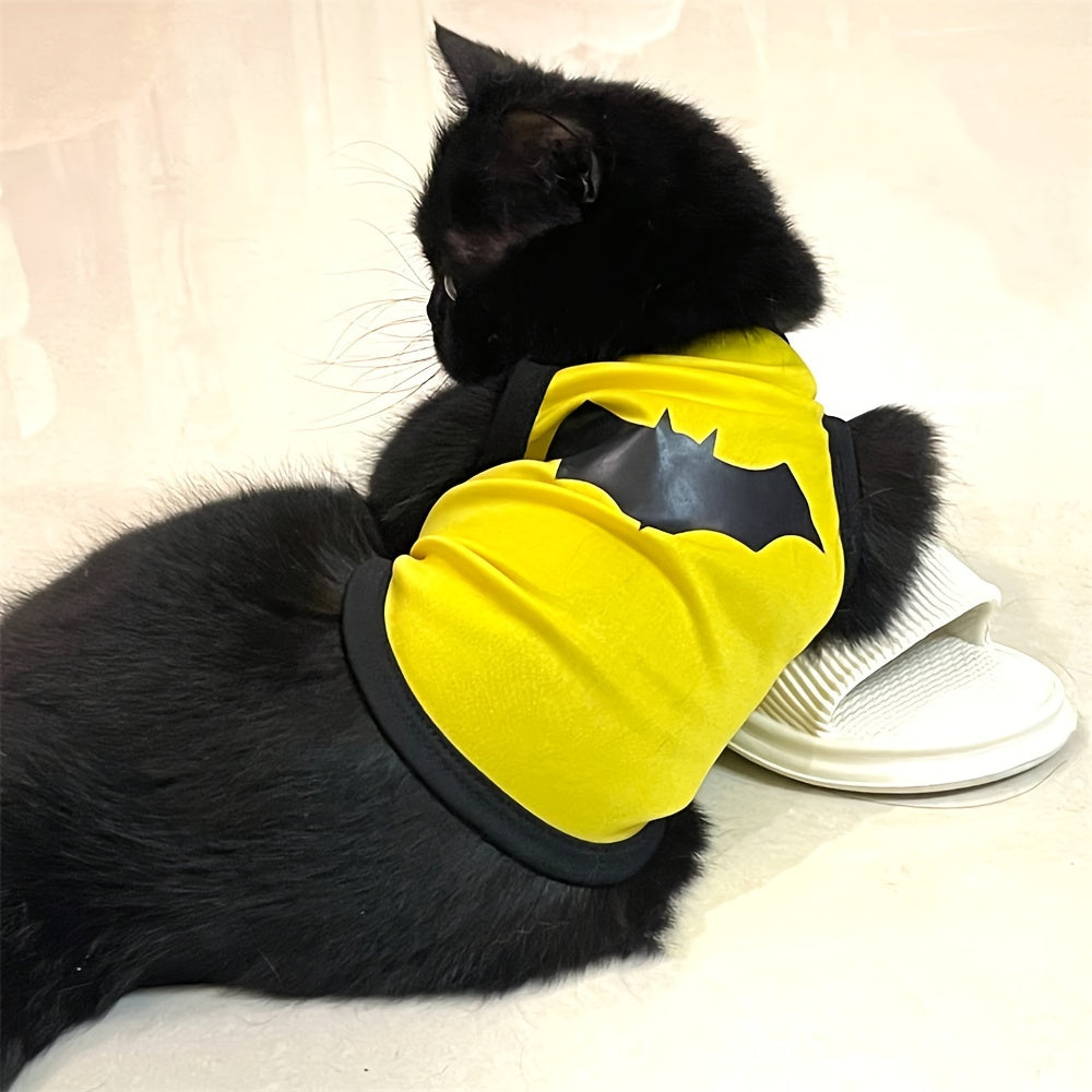Black cat wearing a yellow breathable pet shirt for dogs and cats with a bat design