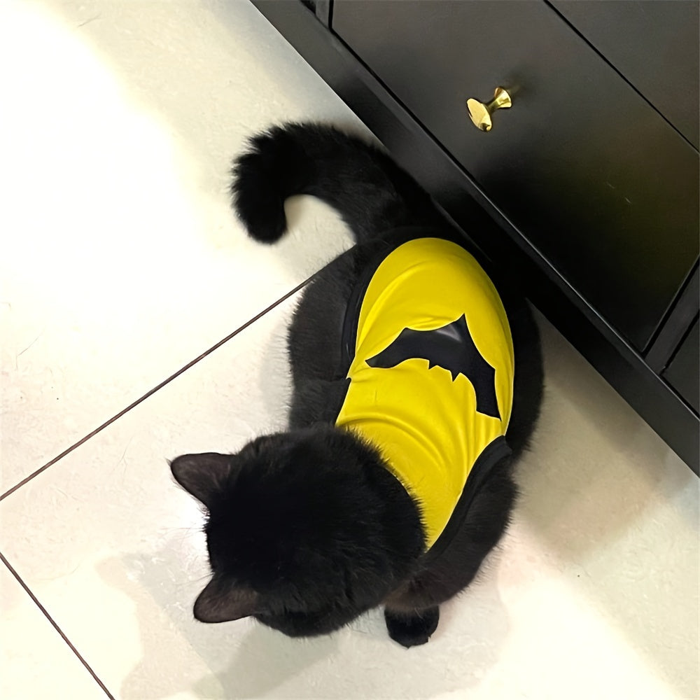 Black cat wearing a yellow superhero shirt, a breathable pet shirt for dogs and cats.