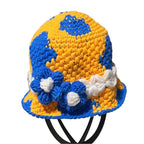 Colorful crochet bucket hat bucket featuring blue and yellow patterns with decorative flowers