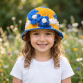 Colorful ThreadsByHannah bucket hat bucket with floral design for kids in a natural outdoor setting