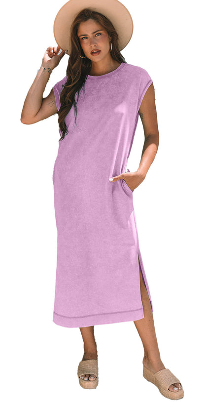 Woman wearing carrot mineral wash t-shirt dress in lavender with pockets side slit hat and sandals