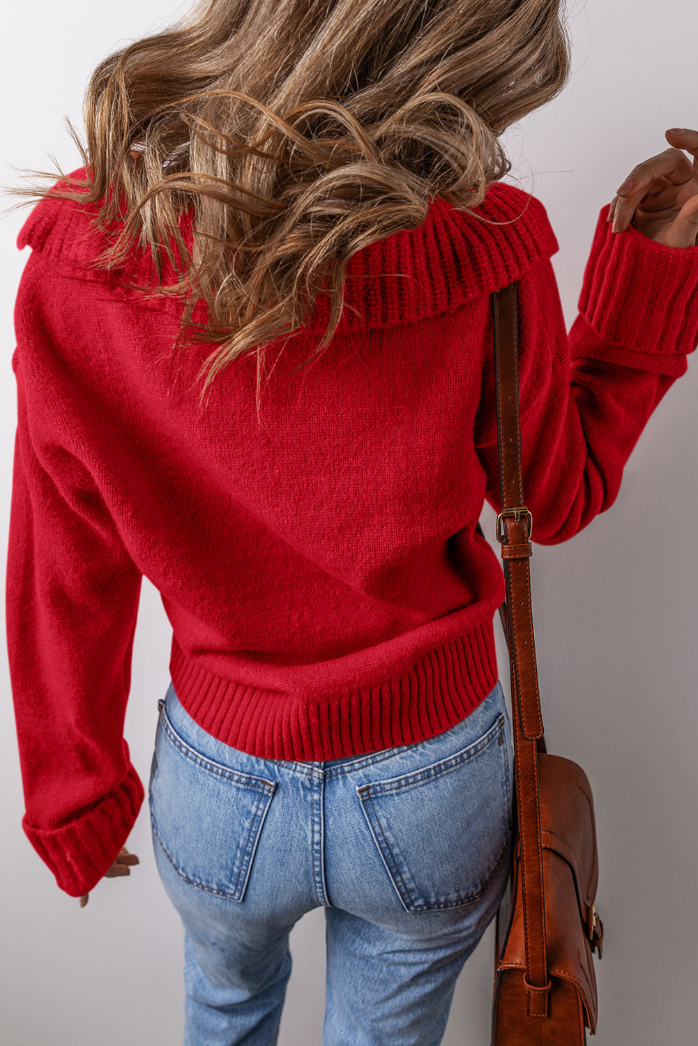 Back view of a woman wearing a red chestnut v neck sweater for women with ribbed cuffs